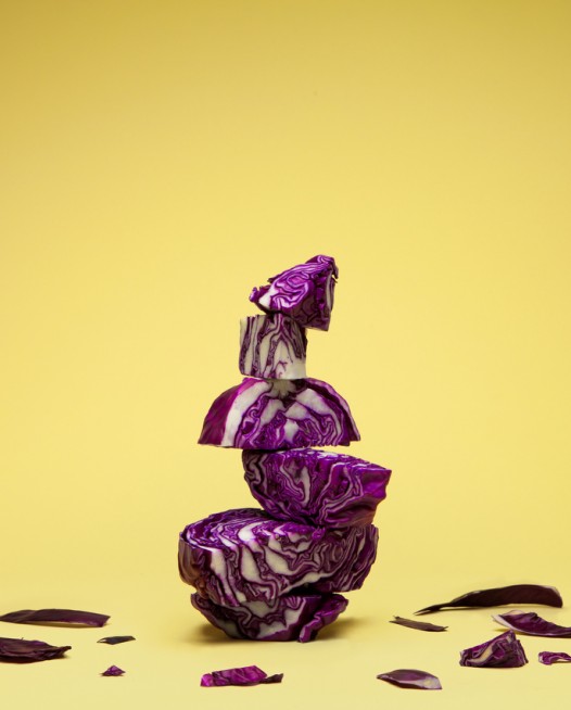 Still Life photo of purple cabbages with yellow background