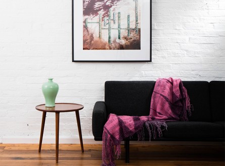 A Vertical Abstract Aerial photo of Australian Landscape in Pink, Purple and Red framed in dark timber in living room