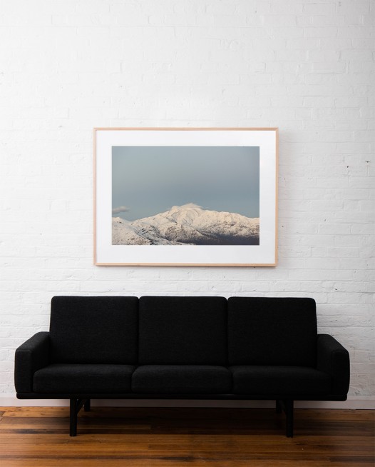 Large Photographic Landscape taken in the Andes, Chile of mountains, snow and clouds framed in raw timber above sofa