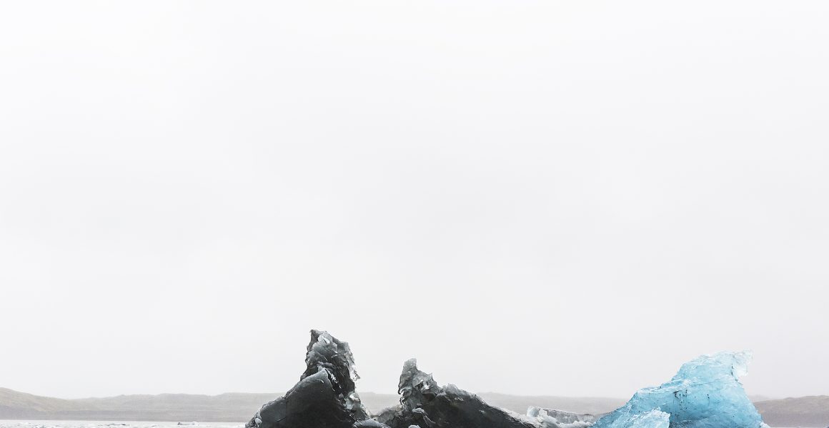 Large Blue and white Icelandic landscape of water, sky, glacier and snow.