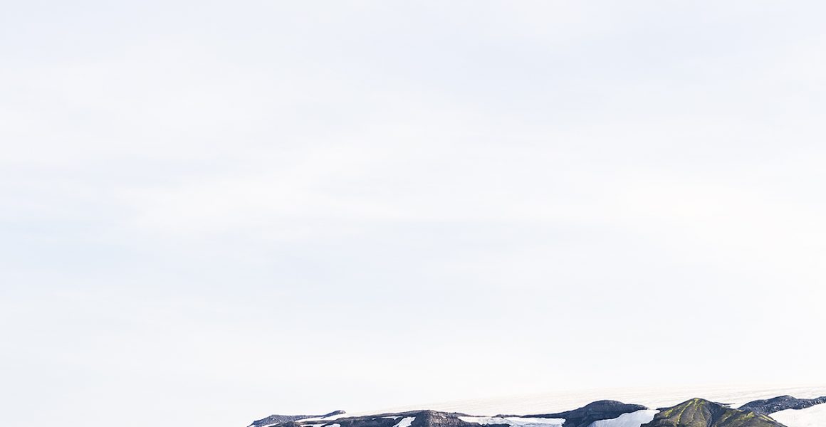 Icelandic Landscape photo in green and blue of glaciers, mountain, snow and blue sky