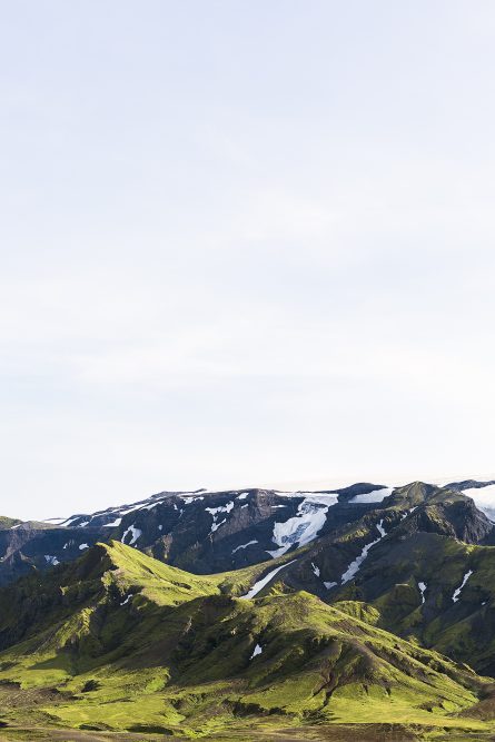 Icelandic Landscape photo in green and blue of glaciers, mountain, snow and blue sky