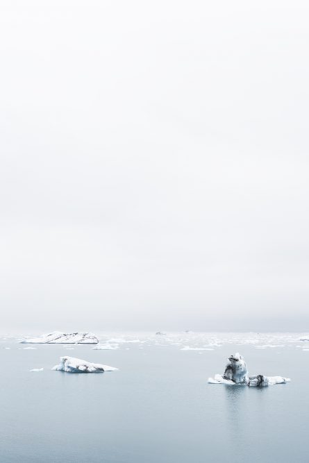 Icelandic Landscape of glacier, snow melting in ocean ater and sky in blue and white