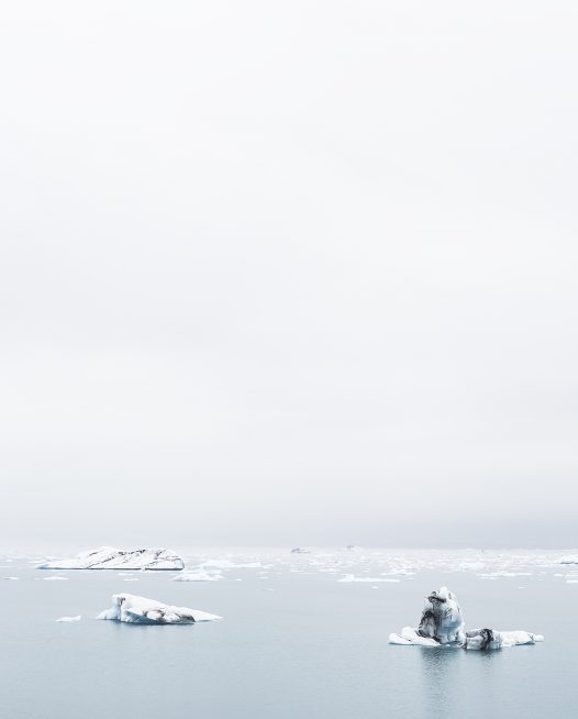 Icelandic Landscape of glacier, snow melting in ocean ater and sky in blue and white