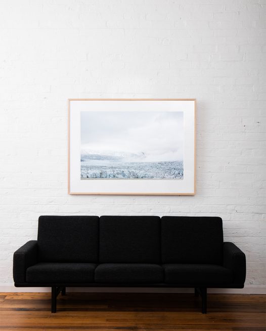 Large Iceland Lanscape of Falling Glacier in blue and whilte. Framed in raw timber on white wall above sofa