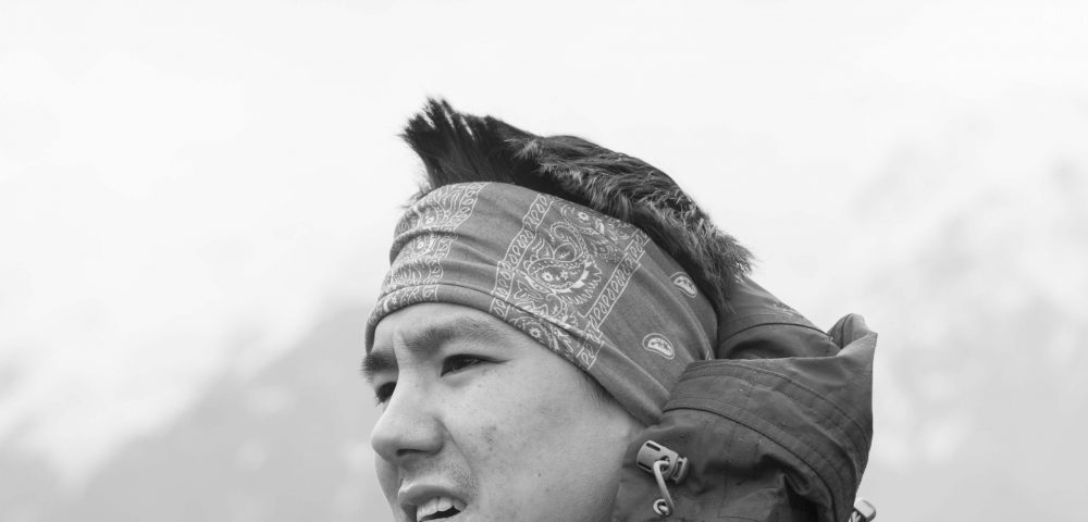 a photographer of Christopher Tung with cloud and mountain background