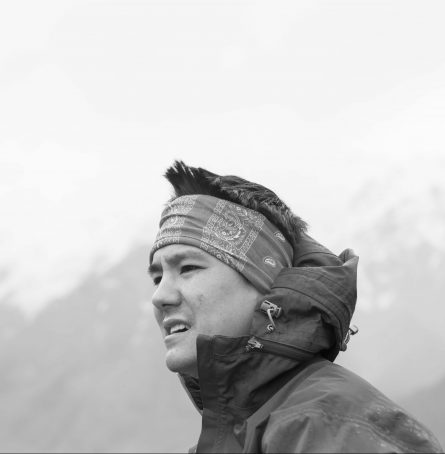 a photographer of Christopher Tung with cloud and mountain background