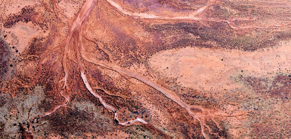 Red and pink aerial photo of the Western Australian landscape.