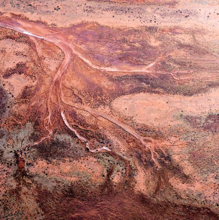 Red and pink aerial photo of the Western Australian landscape.