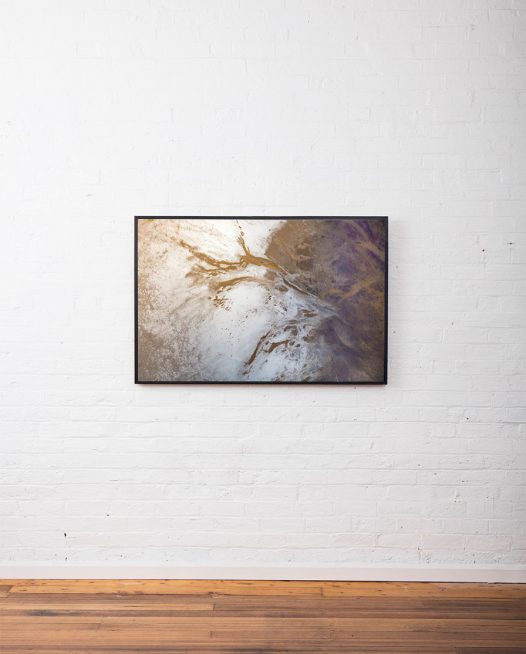 A Large aerial photo of inland Australian landscape in brown, grey and purple colour framed in black timber