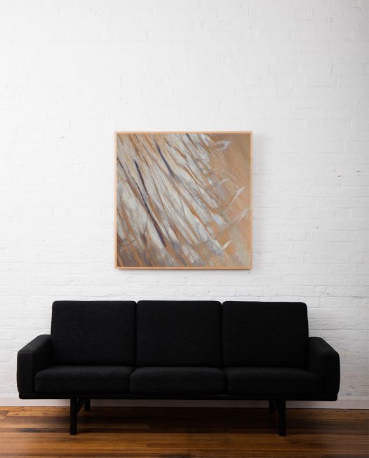 Aerial photo of Lake Eyre of salt , sand and water framed in raw timber above sofa