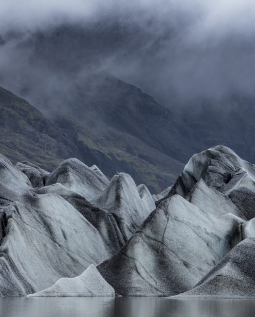 A photo of iceberg with mountain background Iceland