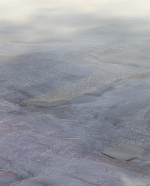 Aerial landscape photo of inland Australia in grey pink blue colours