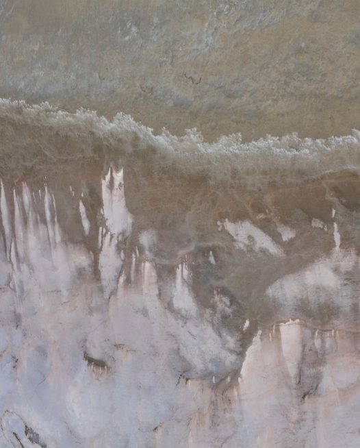 An aerial photo of inland Australia landscape in grey pink and brown color.