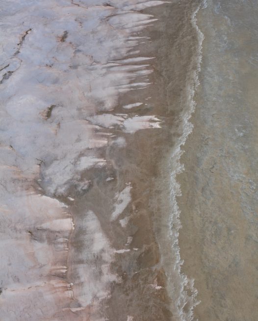 An aerial photo of inland Australian landscape of pink, grey, brown and orange colour