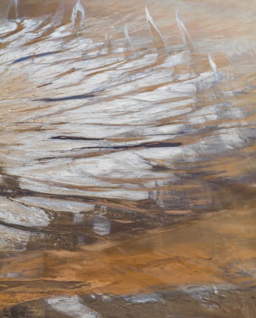 An aerial landscape photo of Australia in brown yellow and silvery colour